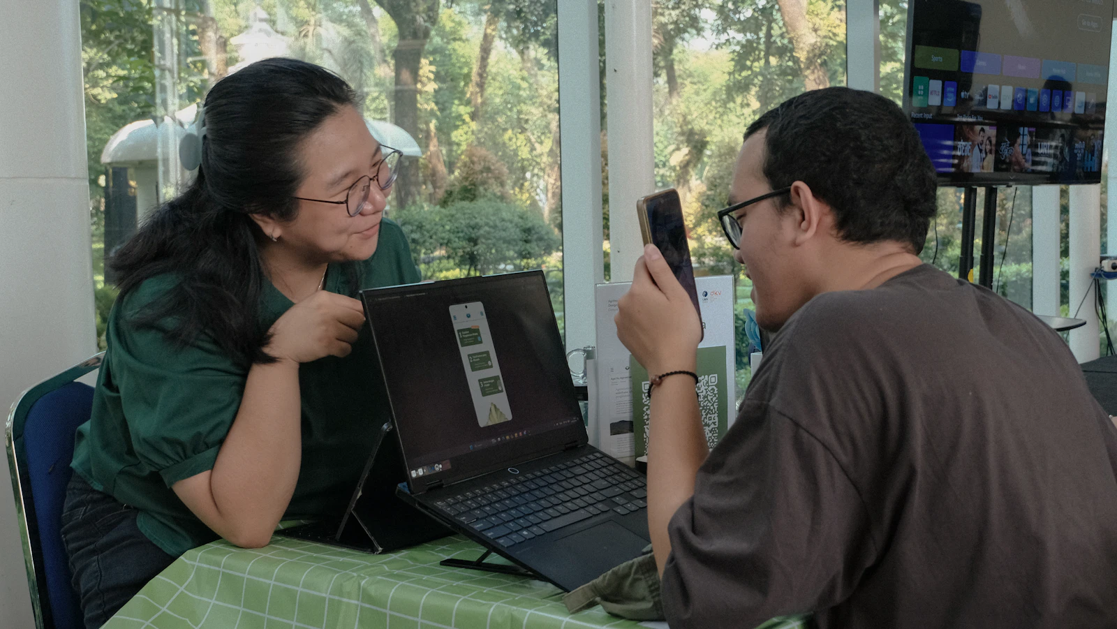 Two people testing and discussing a mobile application